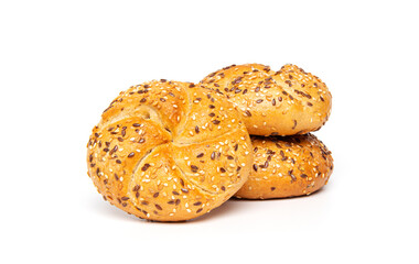 Traditional white kaiser roll with linseeds and sesame seeds isolated on white background