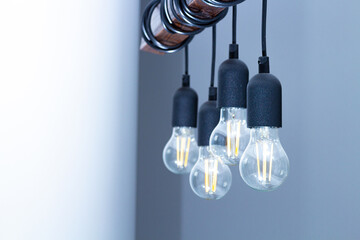 The lamp on the ceiling of the light bulbs located on the wires.