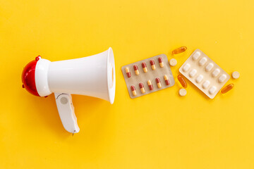 White megaphone with pills and drags. Health care concept
