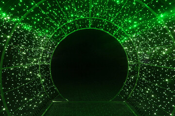 tunnel and illuminations of green white on a black dark background. New Year's Eve Christmas. Photoona festive atmosphere