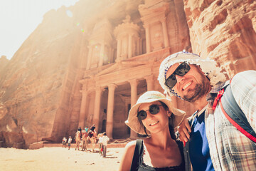 Young handsome couple excited taking selfie in Petra by Treasury landmark. Travelous man and woman,...