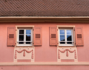 Decorated facade of an old house in Gueberschwihr in Alsace, France