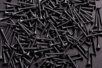 Metal, Stainless Steel Self Tapping Screws on black wooden background