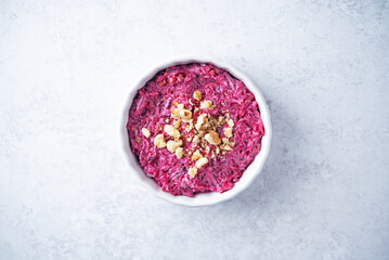 Beetroot mayonnaise salad with walnuts in a bowl