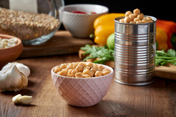 Chickpeas in a small bowl on a wooden table. precooked chickpeas. rustic style