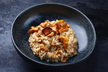 Traditional Italian risotto con finferli with fresh chanterelles and rice served as close-up in a...