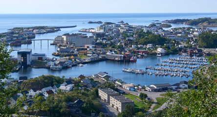 Fototapeta premium Panoramic view on town Svolvaer seen from trail to mount Floya, along the Vestfjorden, Lofoten. Typical views in Lofoten - fjord, mountain, small islands in nearly every direction. Vacation in Lofoten