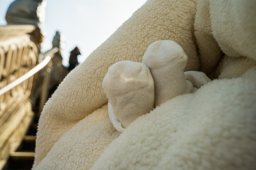 baptism of a child in the church, legs of a newborn baby, close-up of the rite of baptism....