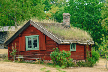 Old scandinavian farm house with green roof in town of Halmstad, Sweden