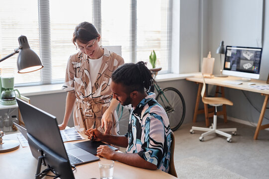 Portrait of two creative designers collaborating on project together in office setting, copy space