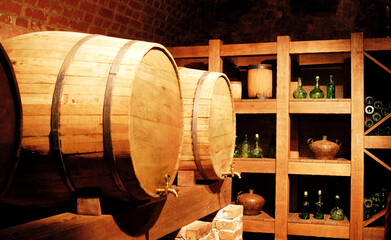 Old wine cellar with barrels and bottles - 544198443