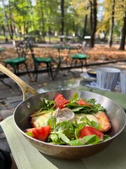 schnitzel with vegetables in a frying pan