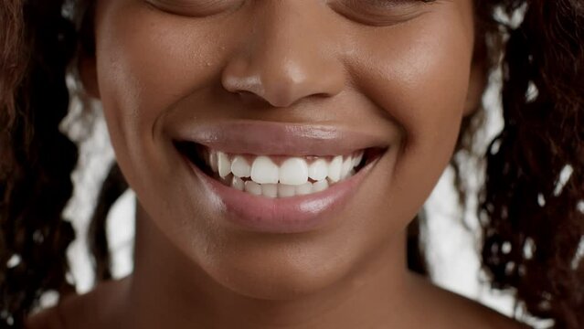 Professional dental hygiene. Close up portrait of young pretty african american woman smiling widely to camera