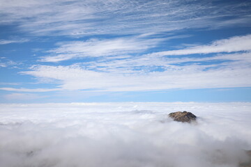 A mountain like floating in a fantastic sea of clouds