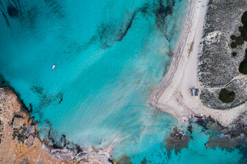 Best beach in Europe with turquoise waters with sand and rocks seen from the air with a drone.