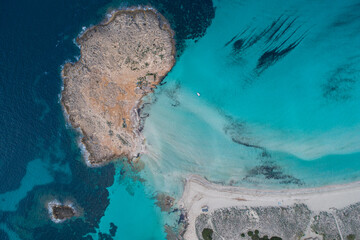 Best beach in Europe with turquoise waters with sand and rocks seen from the air with a drone.