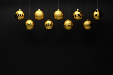 Golden Christmas Baubles with different designs hanging in front of a black stone background....