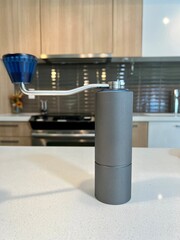 Expensive professional iron gray coffee grinder On the kitchen table For cafe equipment blue handle white table Brew professional craft coffee