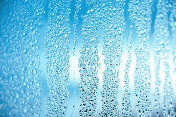 Texture of misted glass in autumn. Drops of water on window