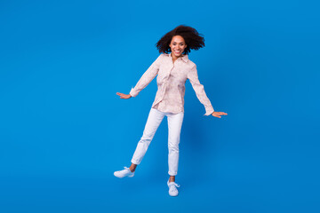 Obraz premium Full length photo of funky sweet girl dressed pink blouse smiling dancing having fun isolated blue color background
