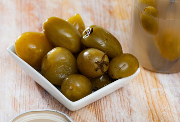 Vegetarian appetizer of salted green tomatoes prepared according to traditional recipe in barrels. Homemade pickles