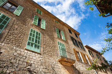 Fototapeta na wymiar Valldemossa, Palma de Mallorca - Spain. September 26, 2022. Its stone houses decorated with colorful plants and green shutters have maintained the traditional flavor 