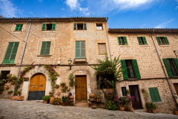 Valldemossa, Palma de Mallorca - Spain. September 26, 2022. Its stone houses decorated with colorful plants and green shutters have maintained the traditional flavor 