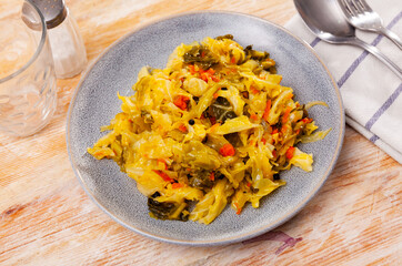 Fresh portion of braised cabbage served on plate. Stewed vegetables.