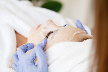 Cheerful woman with a towel on her head face mask clean skin