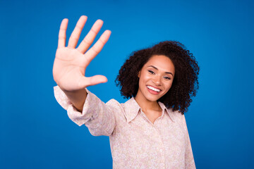 Photo of funny cheerful person arm palm greetings waving give high five isolated on blue color...