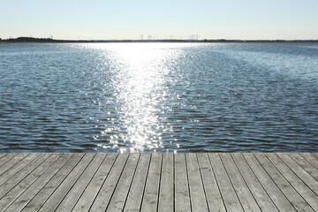 Obraz premium Beautiful view of wooden terrace near river on sunny day