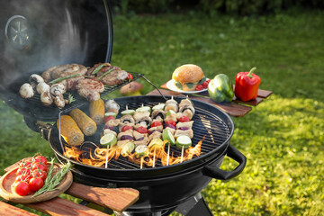 Cooking meat and vegetables on barbecue grill outdoors