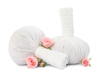 Fototapeta na wymiar Herbal massage bags and beautiful roses on white background. Spa supply