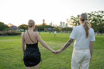lesbian couple holding hands in park