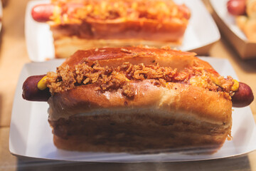 Hot dogs snacks on a table, variety of different hot dog with sausage and onion on beautifully decorated catering banquet table on a corporate christmas birthday party event or wedding celebration