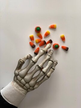 Skeleton Hand Reaching For Candy Corn Mix