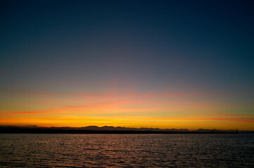 Fototapeta premium Salish Sea Sunset Strait of Georgia. Sunset over the Georgia Strait and the Salish Sea from the mouth of the Fraser River.