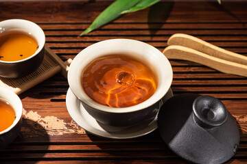 Brewing black tea in ceramic gaiwan during the tea ceremony close-up. 