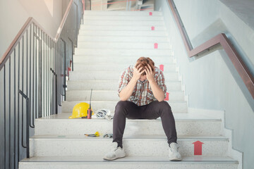 Fototapeta premium Asian construction workers tired sad from stress from hard-working