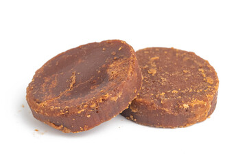 cylindrical dark brown sugar or palm sugar isolated on white background
