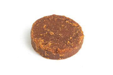 cylindrical dark brown sugar or palm sugar isolated on white background