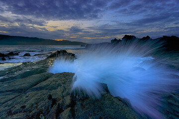 Splash wave over the rock