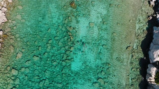 Aerial riser above divers in idyllic clear blue ocean of Pefkos, Rhodes, Greece