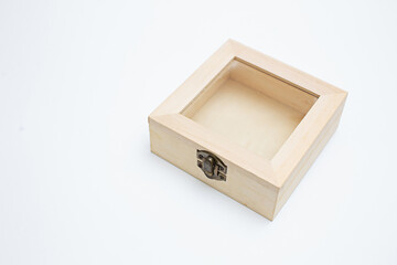 Wooden box for jewelry or small items, white background with copy space.