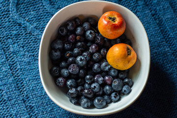 close up of a bowl of blackberries and plums
