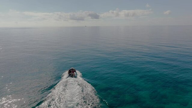 Aerial shot of inflatable boat heading out on Mediterranean with divers