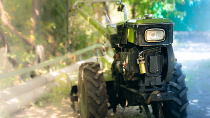 Place on copyspace against the background of a small walk-behind tractor for tillage in...