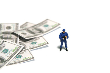 Miniature people toy figure photography. Money transfer security concept. A police officer standing...