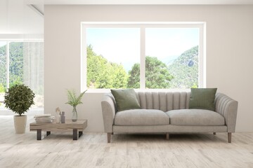 White living room with sofa and summer landscape in window. Scandinavian interior design. 3D illustration