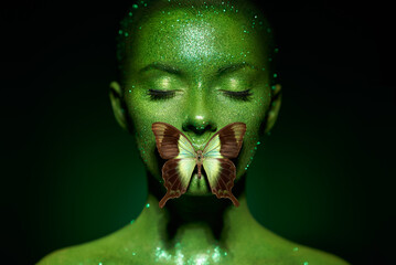 Fashion model woman skin face in bright sparkles with green butterfly colorful neon lights,...